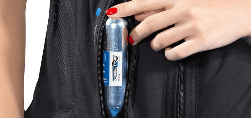 How do you replace a CO₂ cartridge in an airbag vest?